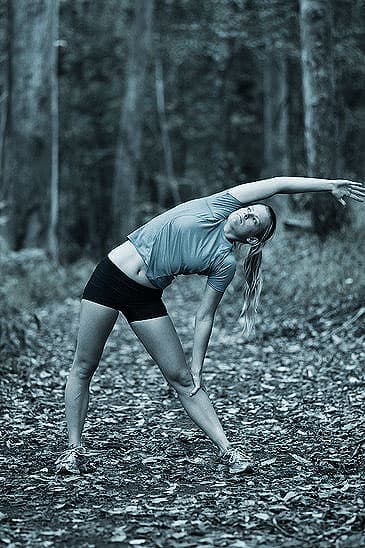Stretching Before a Run in the Woods